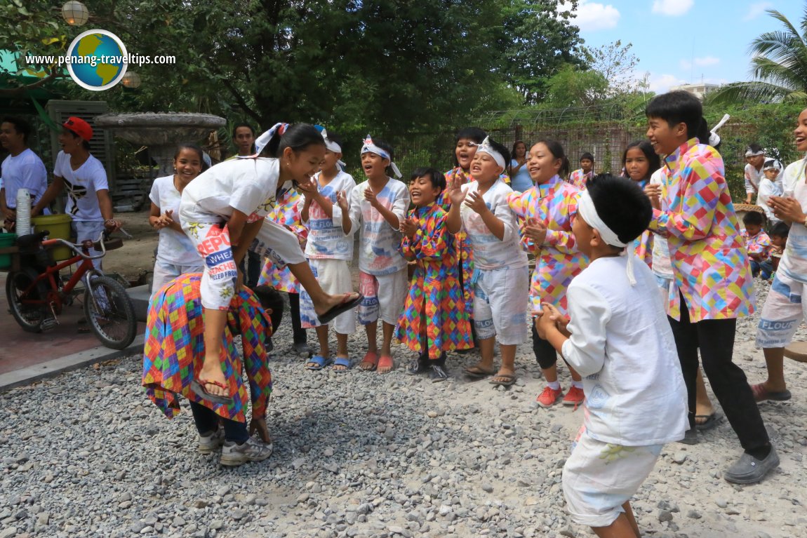 Filipino children playing, on the grounds of 25 Seeds restaurant, in Angeles, Philippines