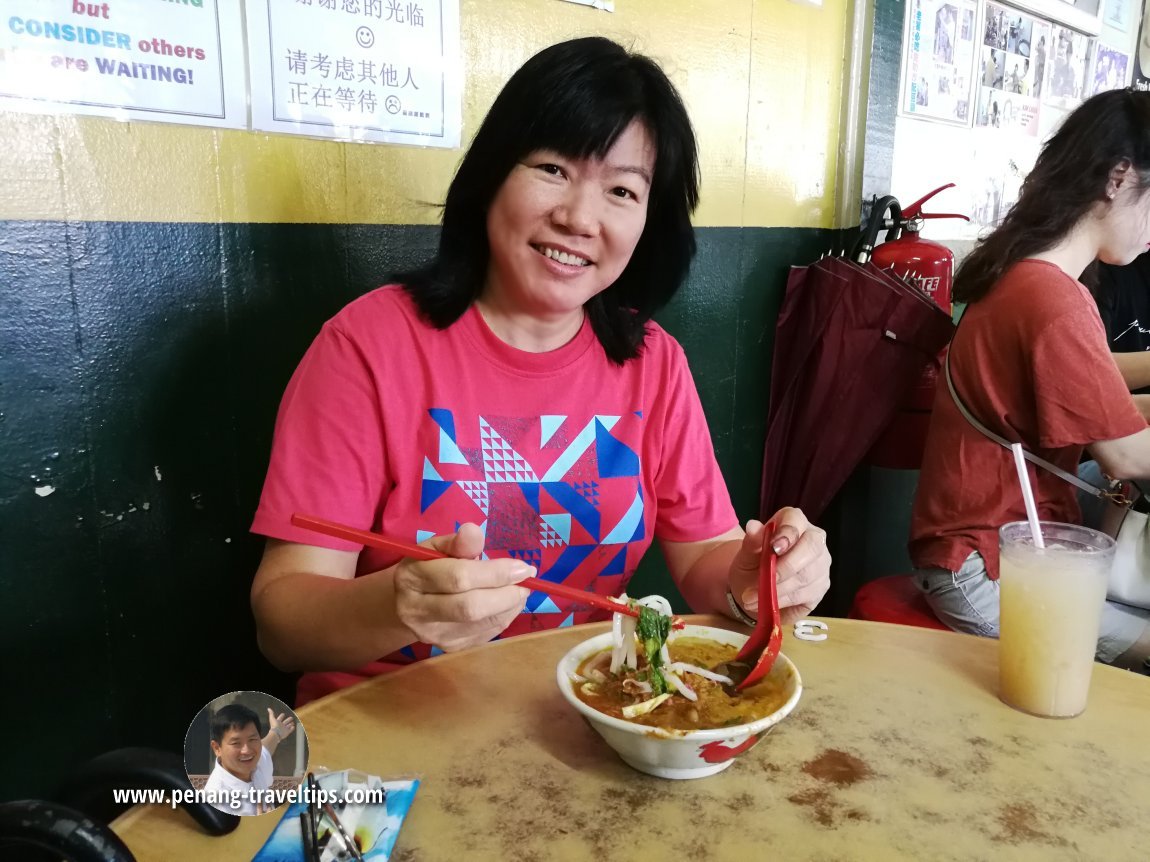 My wife enjoying the laksa in Balik Pulau