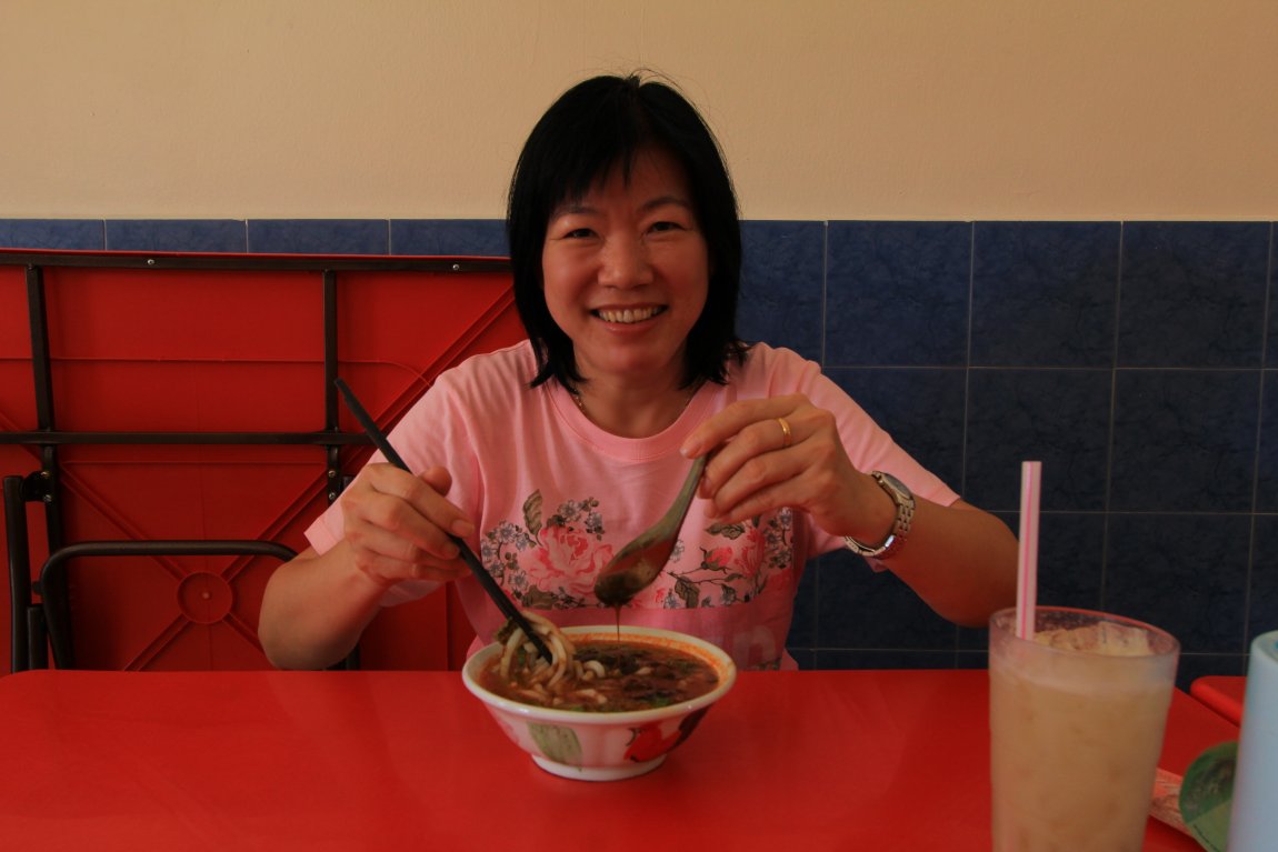 My wife trying out the laksa at Kim Seng Kopitiam