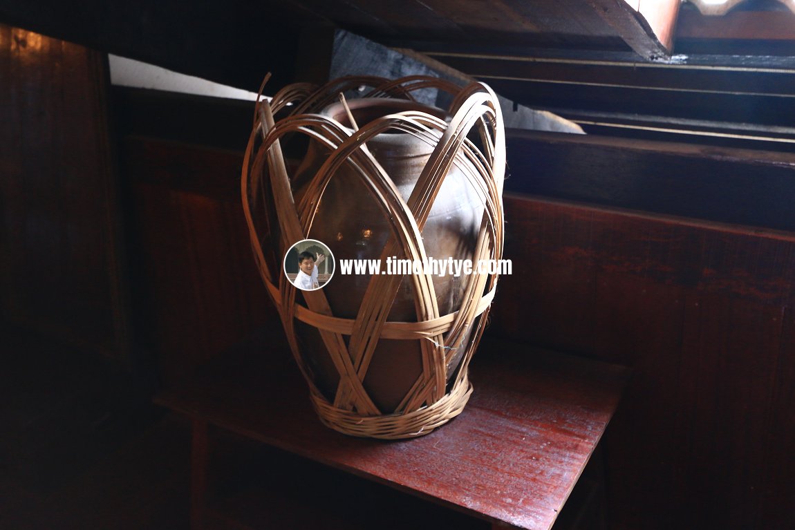 Water vessel with rattan carrier case.