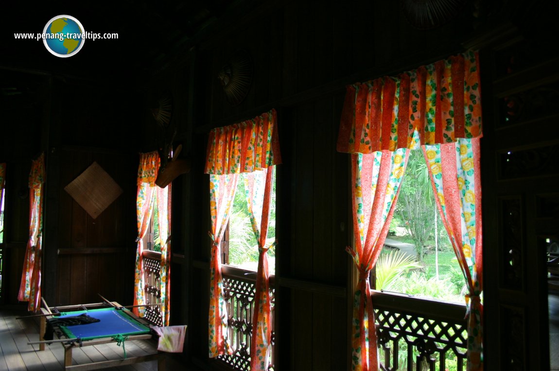 The Malay townhouse has French windows with floral curtains