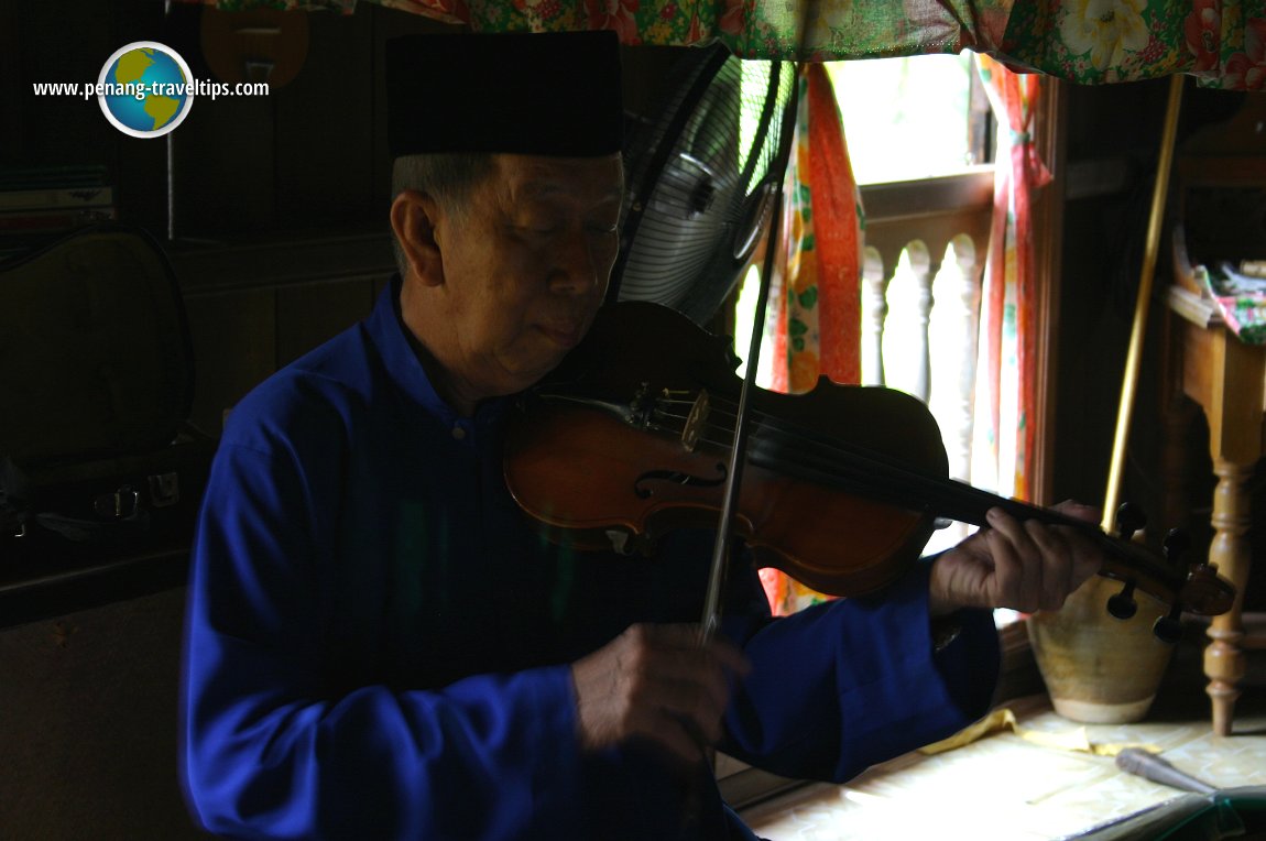 A violinist in the Malay townhouse