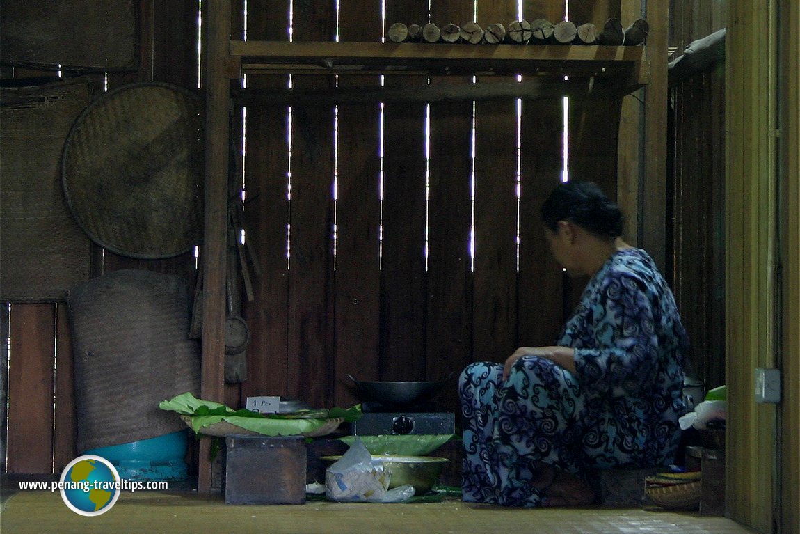Orang Ulu lady making kuih in the kitchen of the longhouse