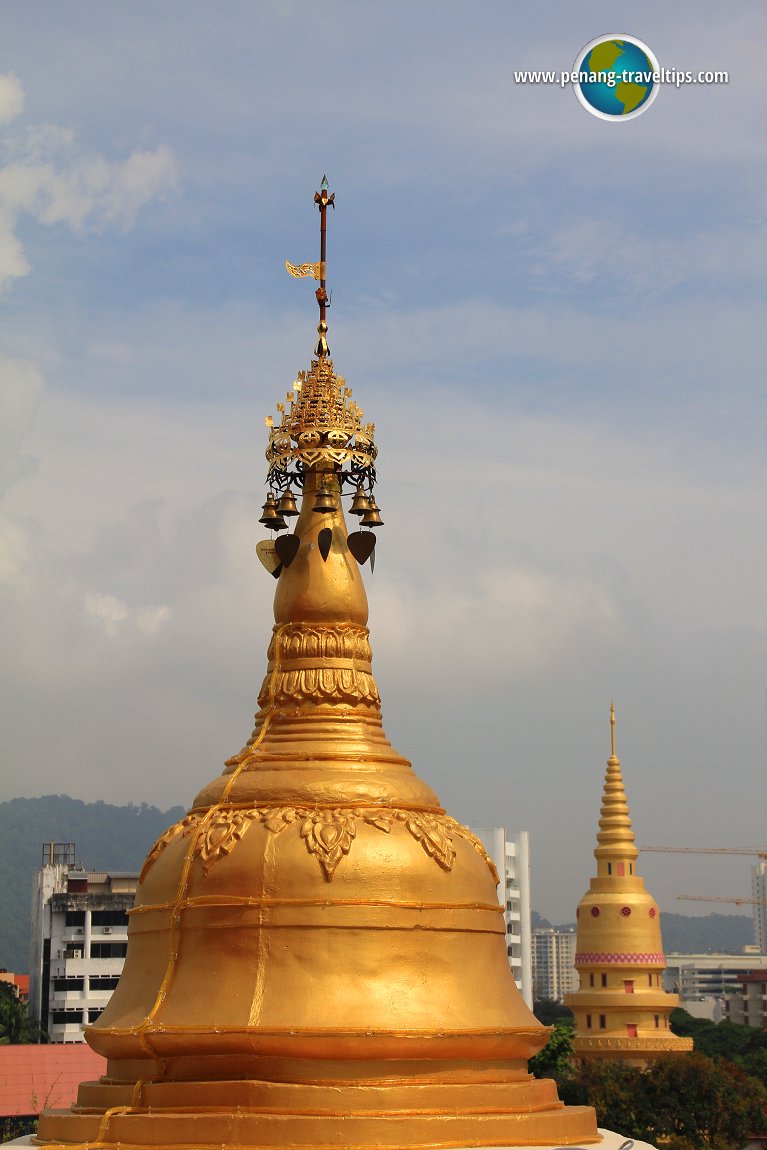 One of the corner stupas of the Golden Pagoda, with the Grand Stupa of neighbouring Wat Chaiyamangkalaram in the distance