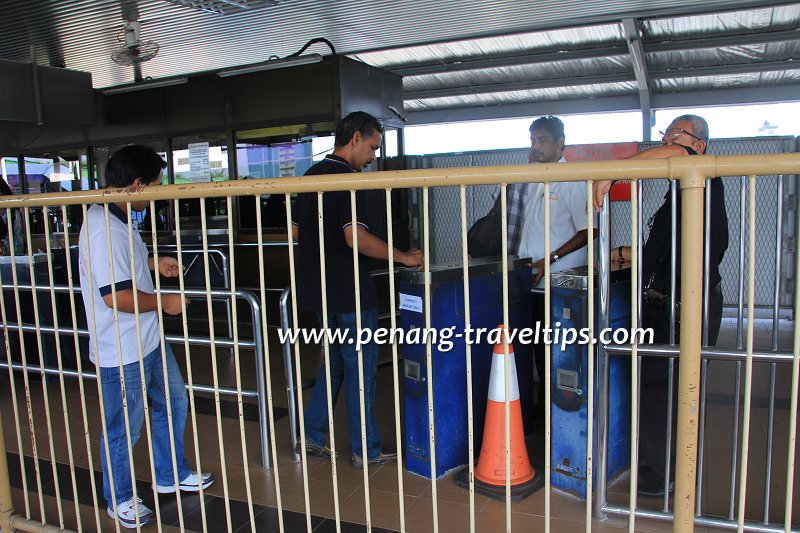 Passenger paying the fare for boarding the Penang Ferry