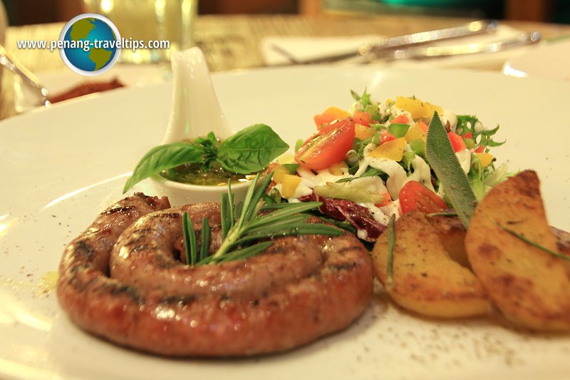 Grilled imported sausage accompanied with roasted potatoes and mix salad