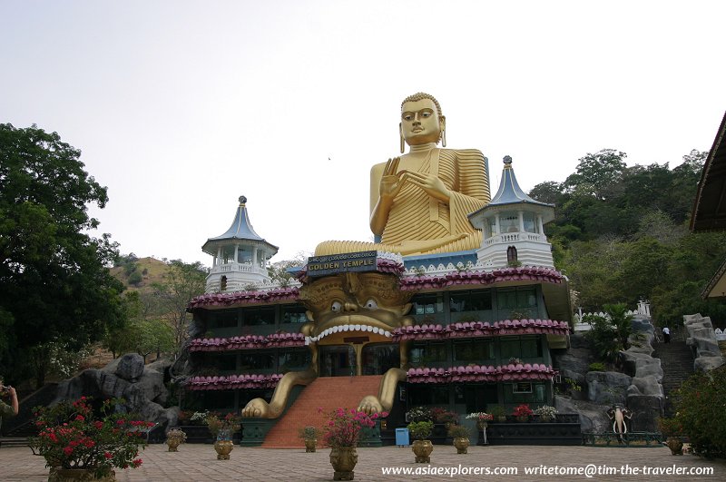 Colossal Buddha statue at the base of Dambulla Cave