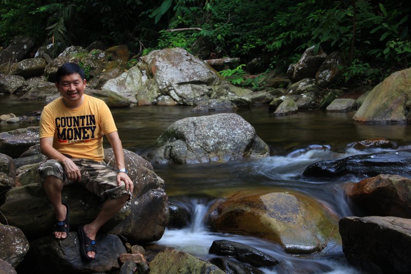 Relaxing beside the cascades of Titi Hayun Recreational Forest in Kedah