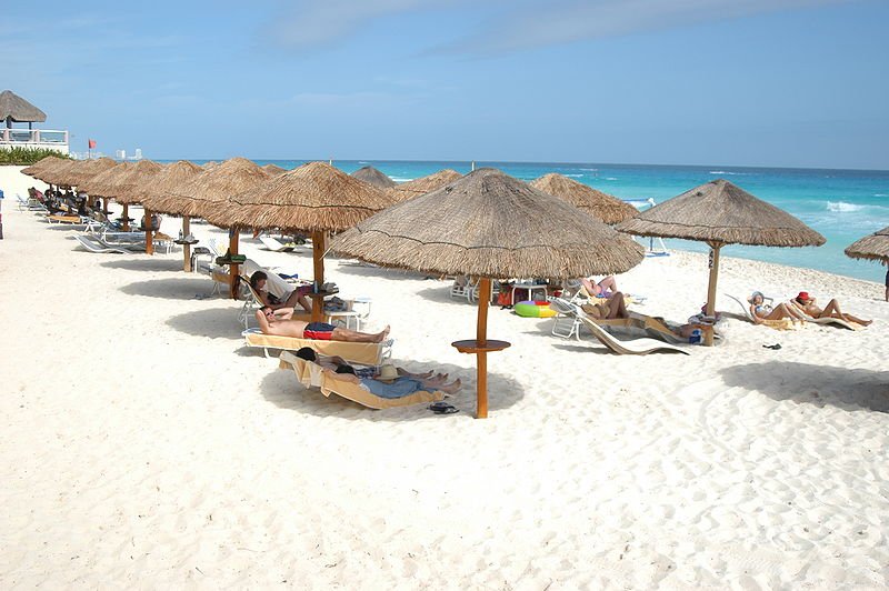 Thatch shelters on a beach in Cancún