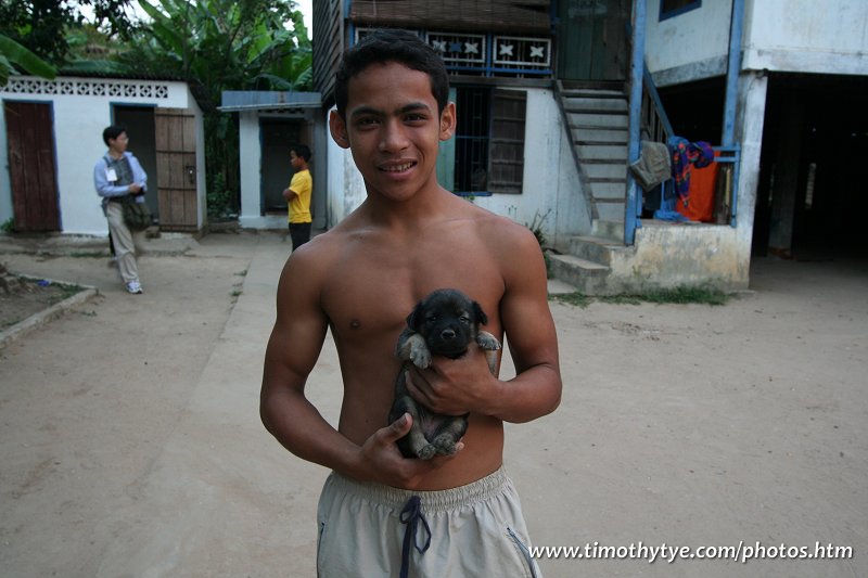 Boy with puppy at the monastery at Angkor Wat