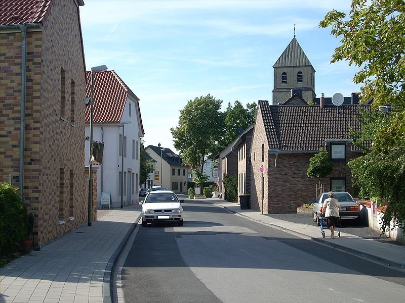Main street in Mündelheim, a neighborhood of Duisburg, with St Dionysius Church on the right