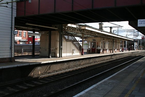 Platform level at the Harrow & Wealdstone Station, with the overhead footbridge in the foreground