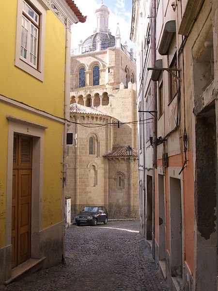 Glimpse of the Cathedral of Coimbra from a narrow street