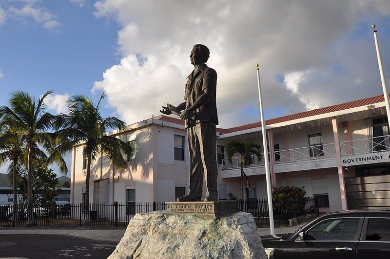 Statue of Dr Claude Wathey in front of a government building in Philipsburg