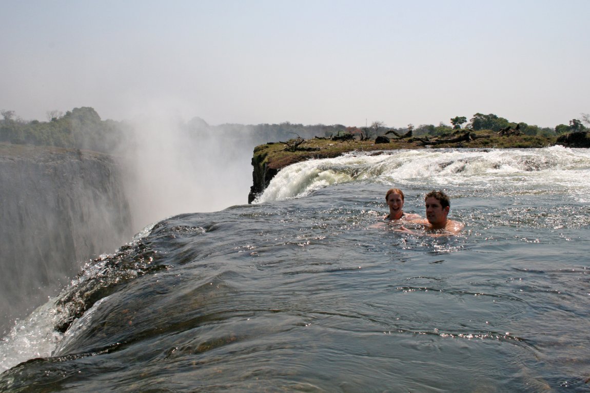 Tourists swimming is a safe pool at Victoria Falls, Zambia