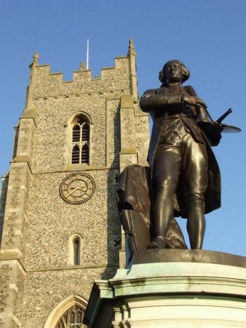 Statue of local artist Thomas Gainsborough with the St Peter's Church in the background