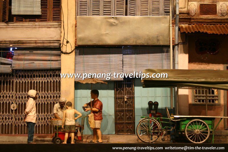 Indian hawker selling kuih on King Street