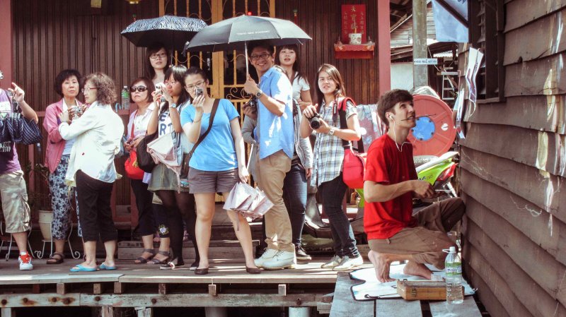 Spectators to an artwork in progess - Ernest Zacharevic at Chew Jetty