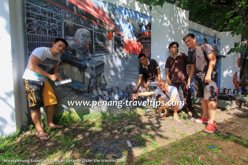 The Wall Art Team posing with the mural of their creation