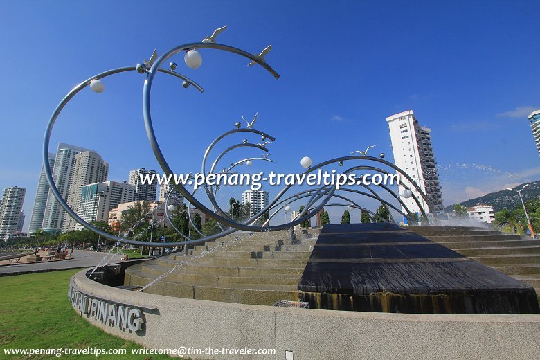 View of the Wave of Prosperity, with the skyscrapers of Gurney Drive in the background